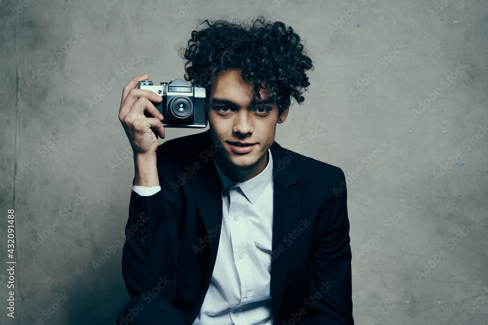 guy holding a camera in his hand retro classic suit curly model man guy holding a camera in his hand retro classic suit curly model man