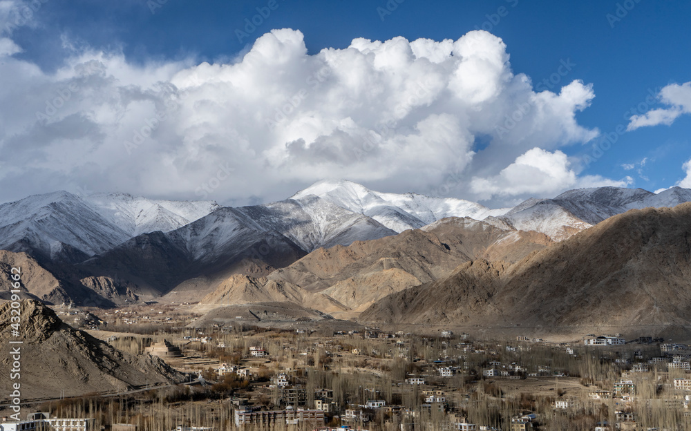 beautiful landscape of mountains with sun over them in ladakh. captured during snowfall.