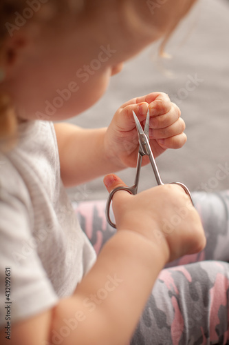 close-up of small child cutting his own fingernails