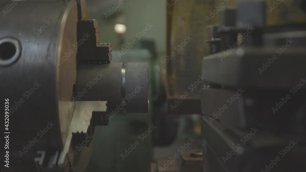 A lathe cuts metal, close-up. Old lathe with an iron billet, working process. A lathe cuts metal, close-up. Old lathe with an iron billet, working process.