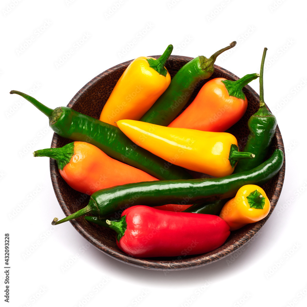 Wooden bowl full of Chili or sweet peppers isolated on white background