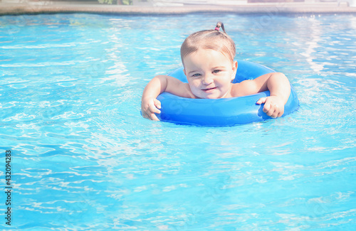 Smiling baby in the pool.