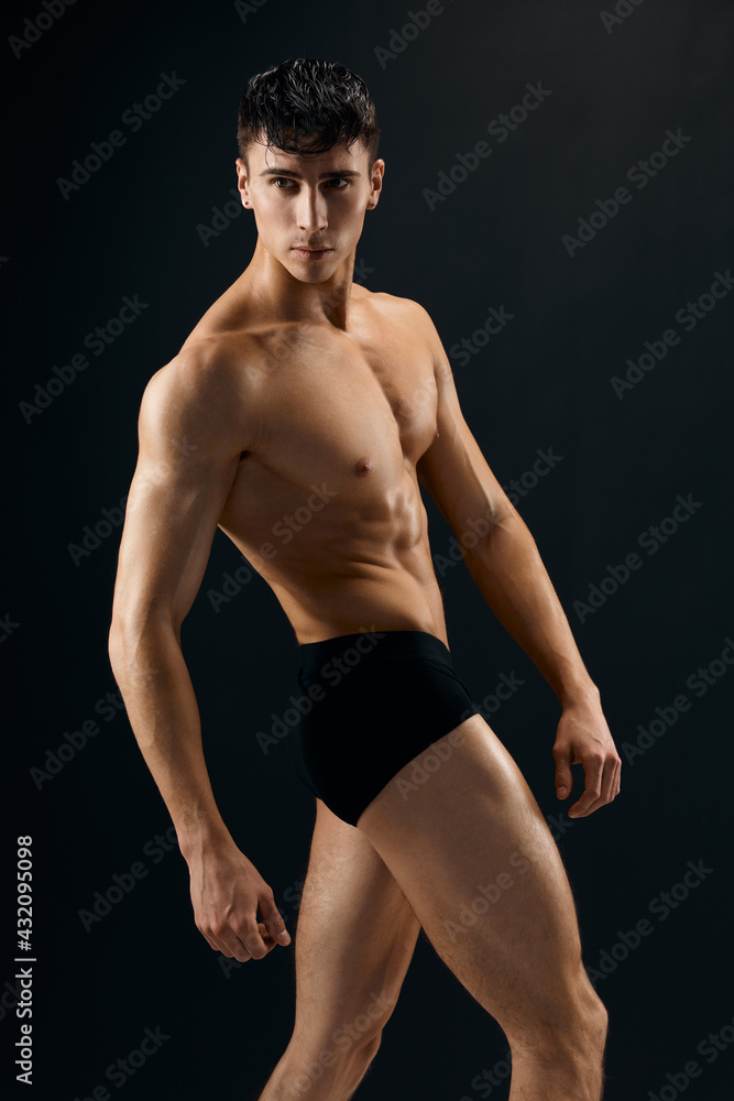 handsome man muscular naked torso posing in studio