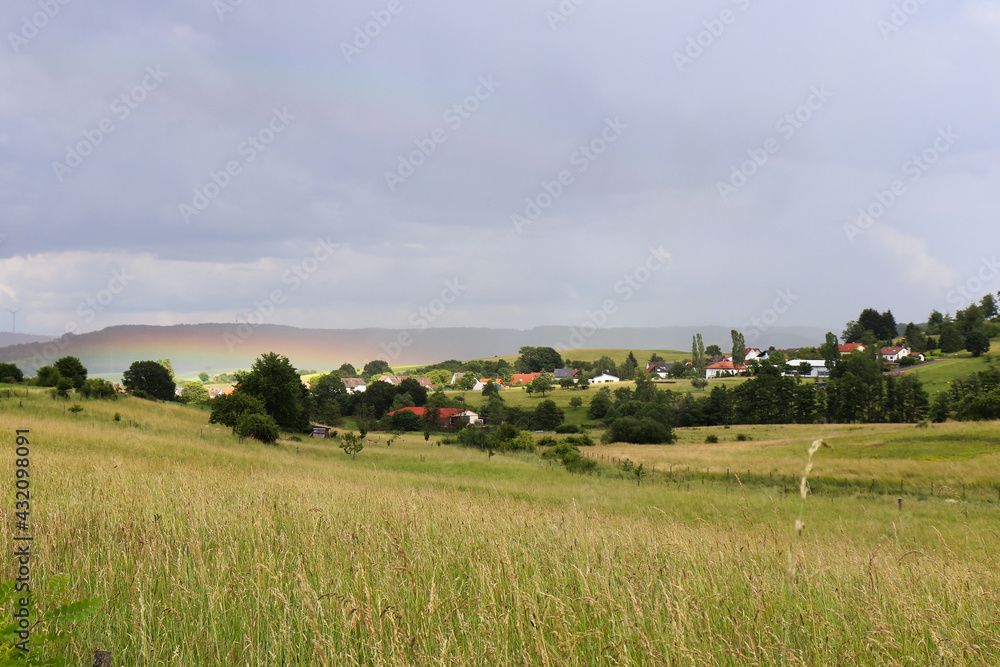Colorful rainbow over Potzbach, Germany on a sunny spring night. Colorful rainbow over Potzbach, Germany on a sunny spring night.