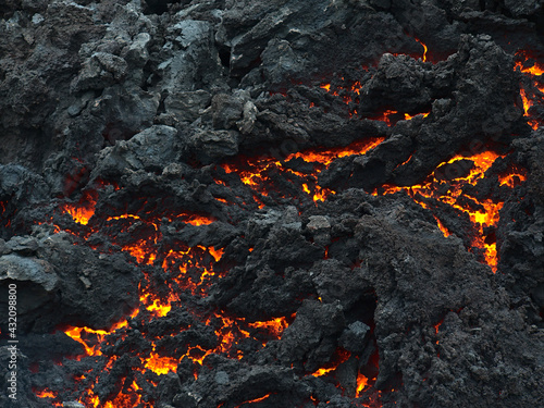 Closeup view of cooling down lava rocks with orange glow after the eruption of a volcano in Geldingadalir valley near Fagradalsfjall mountain, Grindavík, Reykjanes peninsula, southwest Iceland.