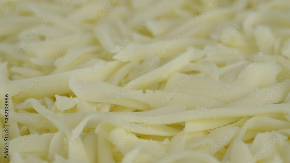 grated mozzarella cheese close up. Sliding shot. 4K UHD video grated mozzarella cheese close up. Sliding shot. 4K UHD video