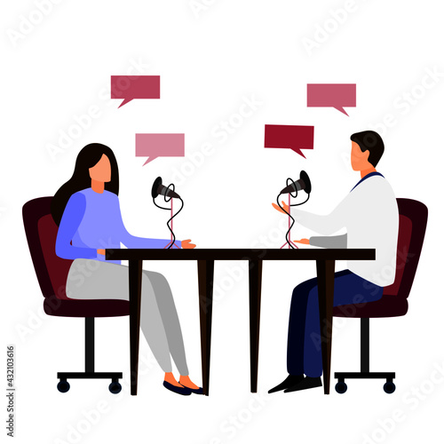 2 people are having conversation via microphone white sitting at the opposite side of table