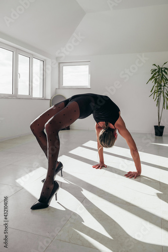 Young elastic woman in a wheel yoga pose
