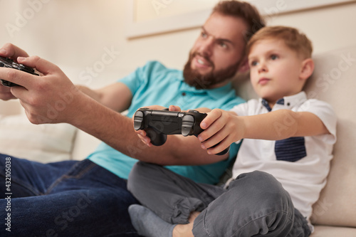 Father and son playing videogame