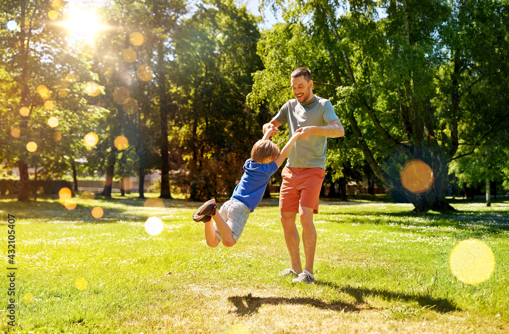Fototapeta premium family, fatherhood and people concept - happy father with little son playing in summer park