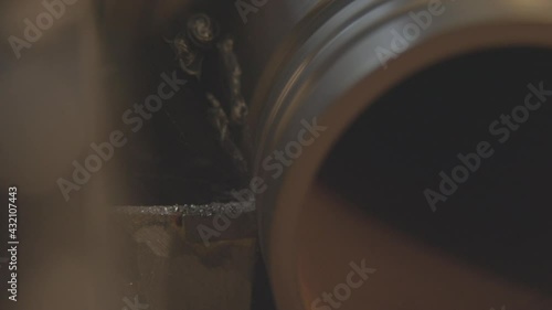 A lathe cuts metal, close-up. Old lathe with an iron billet, working process.