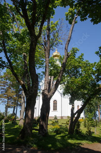 Orthodox church among the trees on a sunny summer day.