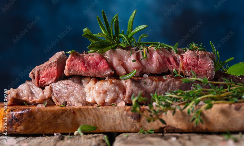 Medium rare steak with rosemary close-up Medium rare steak with rosemary close-up
