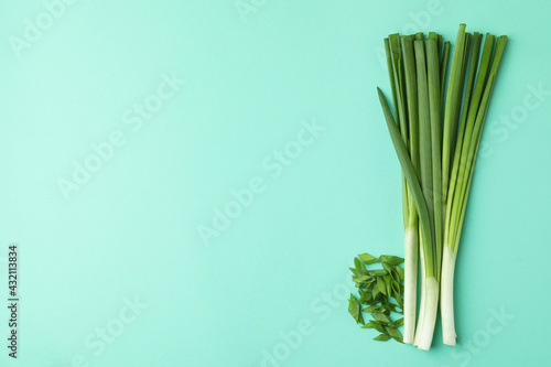 Bunch of green onion on mint background
