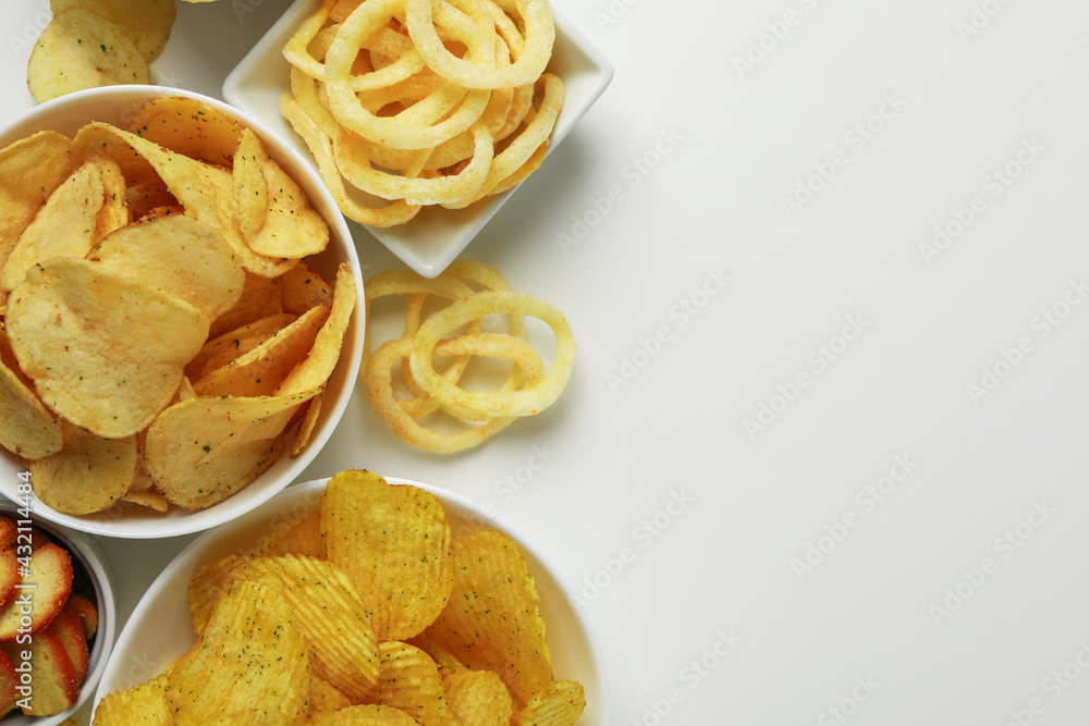 Bowls with different snacks on white background