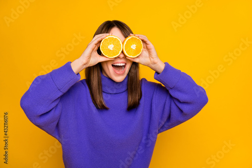 Wallpaper Mural Portrait of attractive foolish cheerful girl holding orange slices closing eyes having fun good mood isolated over bright yellow color background Torontodigital.ca
