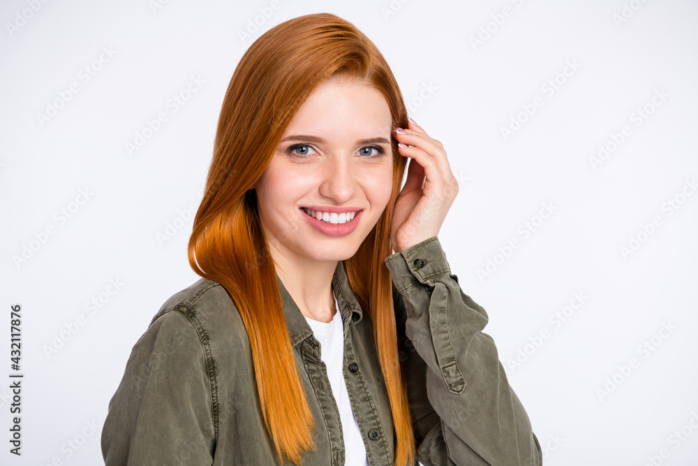 Photo of optimistic ginger hair lady touch hair wear grey shirt isolated on white color background Photo of optimistic ginger hair lady touch hair wear grey shirt isolated on white color background