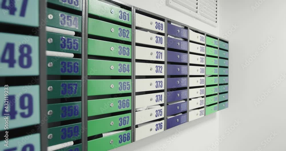 Colorful mailboxes in the lobby of a residential building with apartment numbers. Colorful mailboxes in the lobby of a residential building with apartment numbers.
