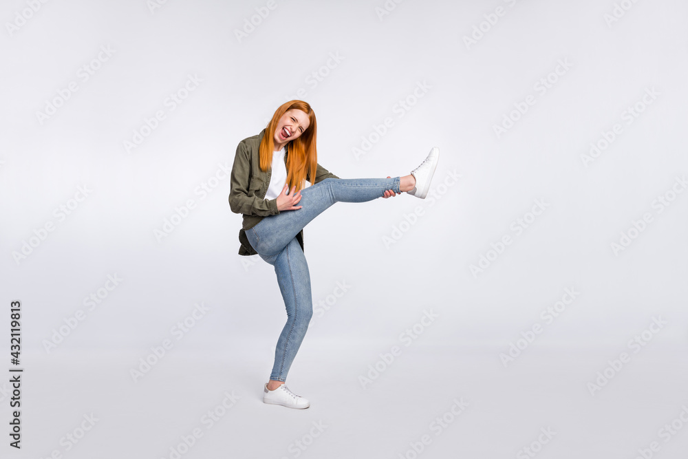 Full size photo of happy excited good mood cheerful woman hold leg playing guitar isolated on grey color background Full size photo of happy excited good mood cheerful woman hold leg playing guitar isolated on grey color background