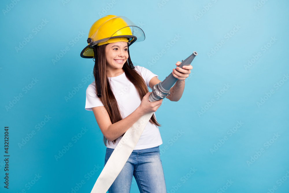 Portrait of attractive trendy cheerful girl holding anti fire equipment water pump isolated over vivid blue color background Portrait of attractive trendy cheerful girl holding anti fire equipment water pump isolated over vivid blue color background