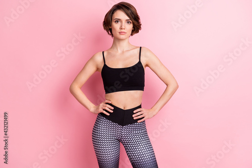 Photo of attractive charming young woman hold hands waist training regime isolated on pink color background © deagreez