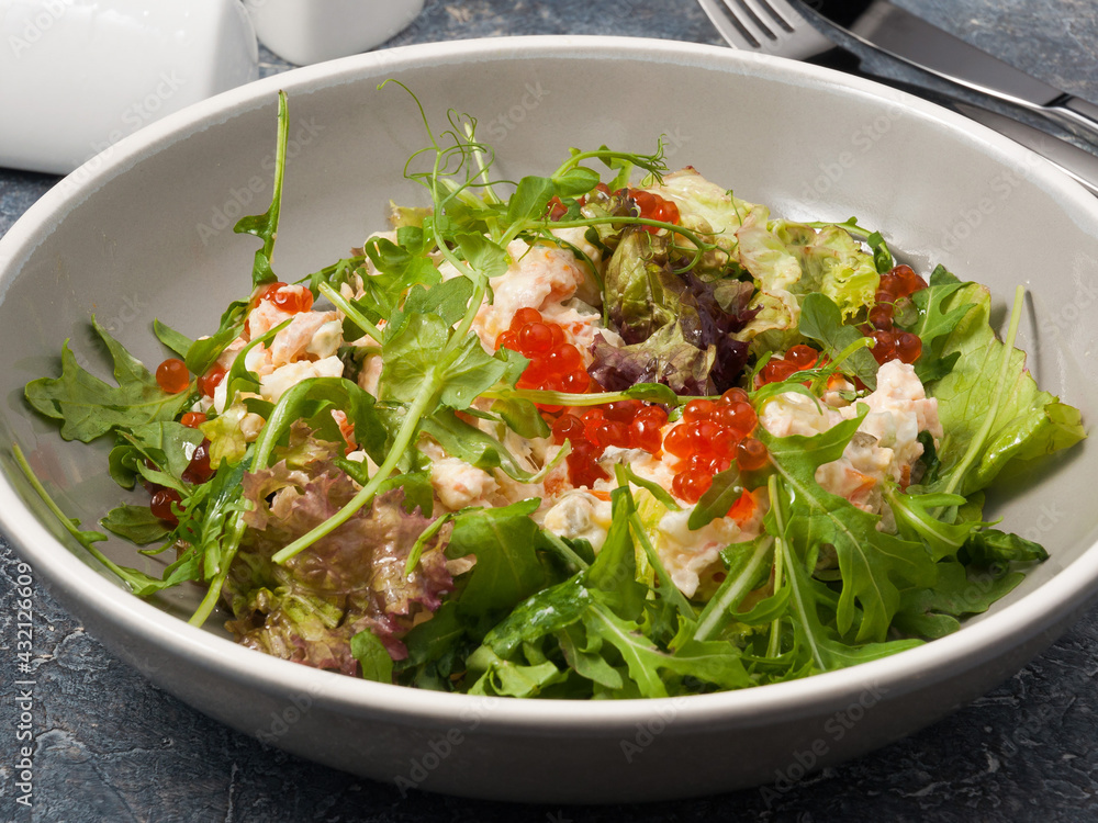 Olivier salad with smoked salmon, red caviar and arugula Olivier salad with smoked salmon, red caviar and arugula