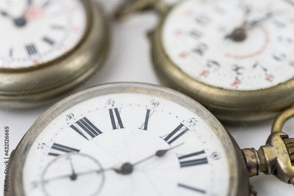 Scenic view of old pocket watches on white background Scenic view of old pocket watches on white background
