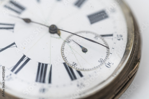 Close up view of pocket watch on white background