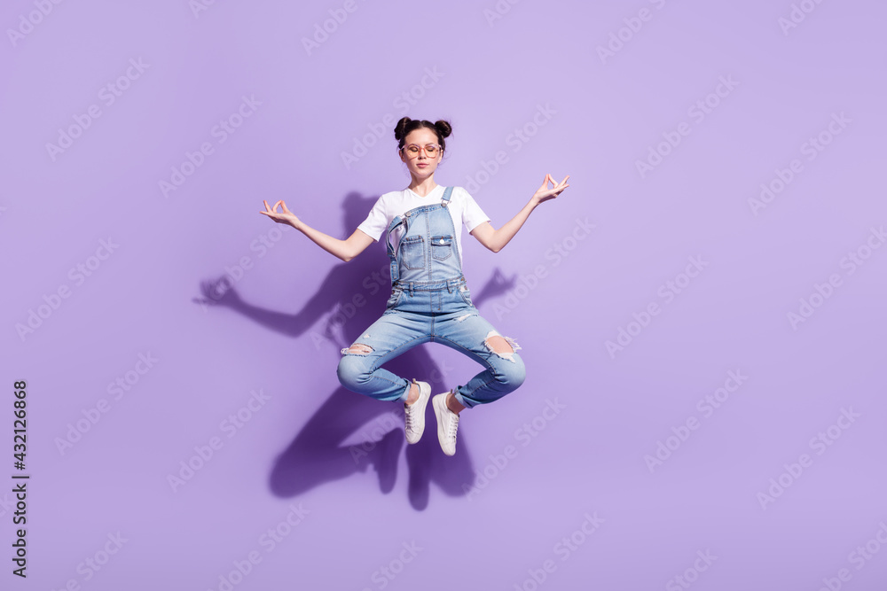 Full length portrait of charming girl closed eyes hands fingers meditate isolated on purple color background Full length portrait of charming girl closed eyes hands fingers meditate isolated on purple color background