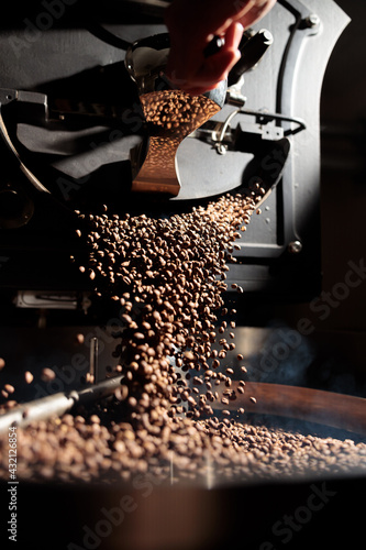 Coffee processing. Roastery, roasting machine and fresh beans photo