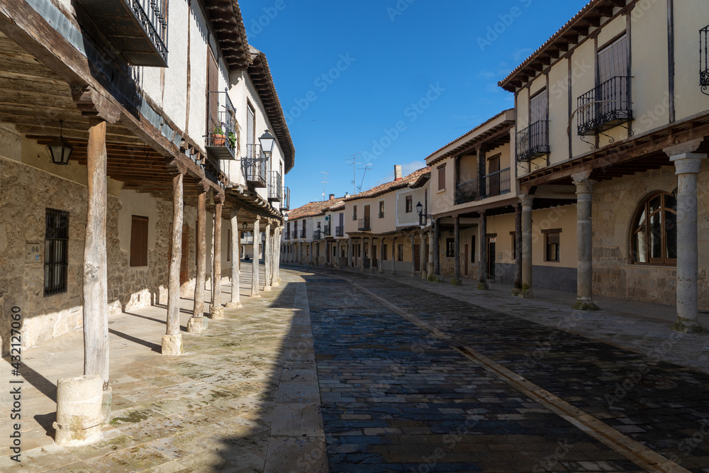 Streets with a traditional Castilian architecture with its houses with arcades in Ampudia, Palencia, Castilla y León, Spain.