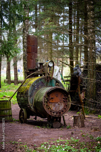 Illegal alcohol production apparatus positioned among the trees in the forest. Photo taken in low light conditions. © Fotoforce