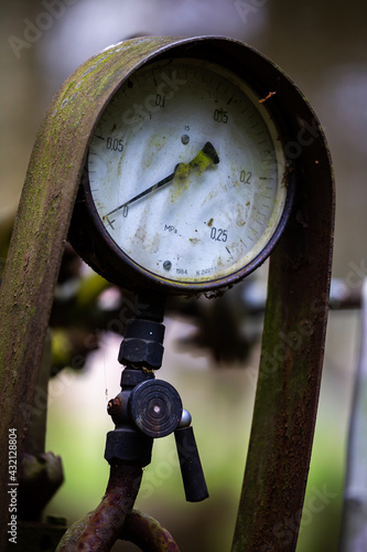 Pressure gauge on an illegal installation for the production of moonshine (alcohol). Photo taken in low light conditions. photo