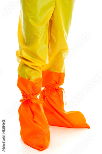 Man wearing yellow protective pants and orange shoes isolated on white background
