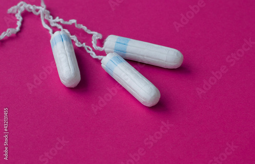 three female tampons lie on a bright background. Feminine hygiene products. Copy space. High quality photo