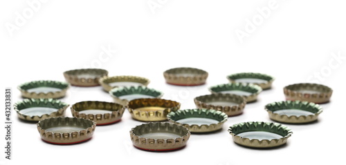 Metal beer bottle caps pile isolated on white background