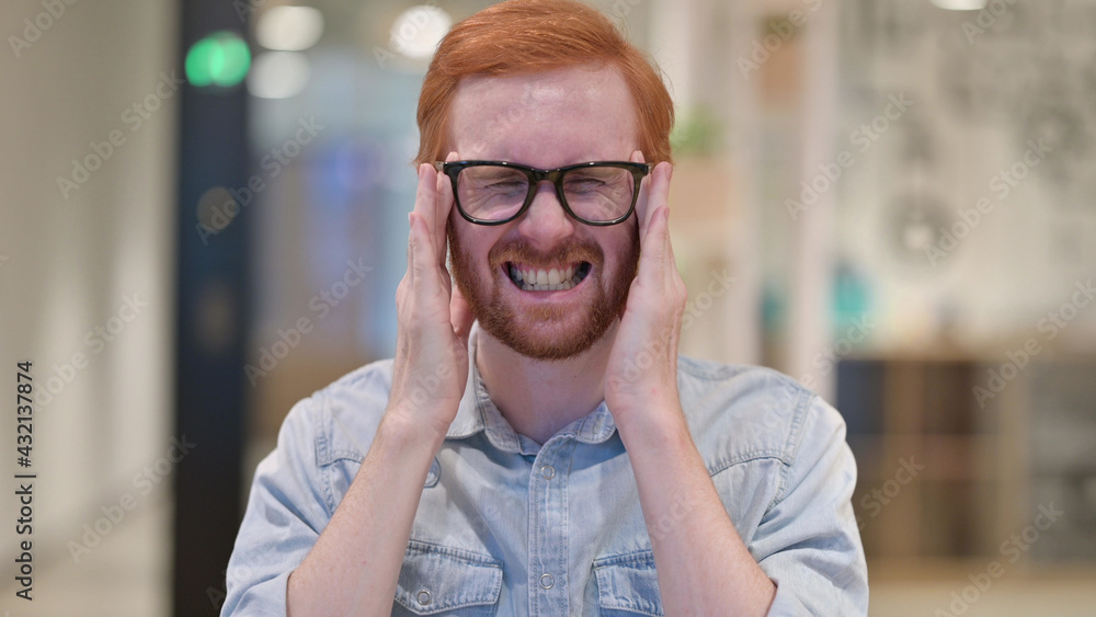 Exhausted Young Redhead Man having Headache