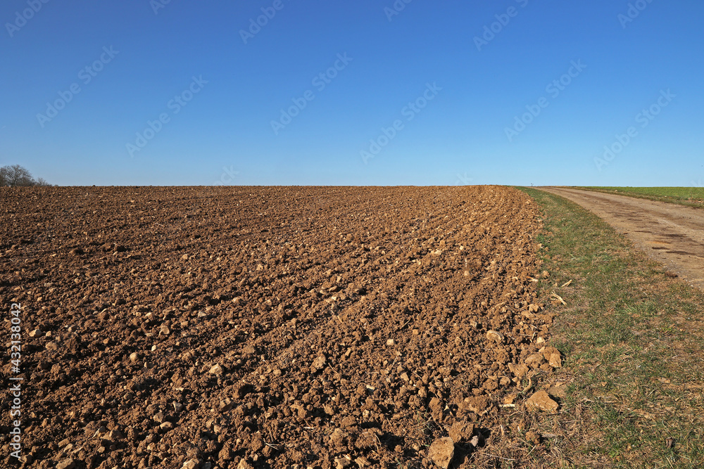 Spring landscape with arable land and meadows Spring landscape with arable land and meadows