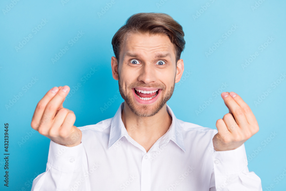 Photo of amazed young man show money gesture demand money profit isolated on pastel blue color background Photo of amazed young man show money gesture demand money profit isolated on pastel blue color background