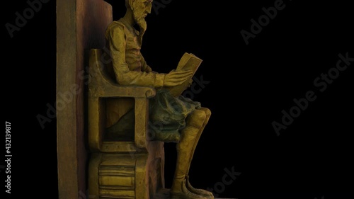 Don Quixote of La Mancha reads a book-rotation - 3d model animation on a black background photo