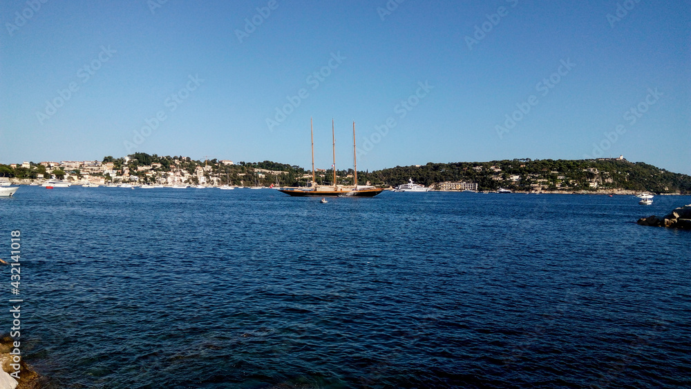 Yachts and boats in the harbor. Beautiful panoramic landscape of Villefranche-sur-mer on a sunny day. A wonderful trip to the Cote d'Azur in France. Scenic harbour view of the city of the sea country.
