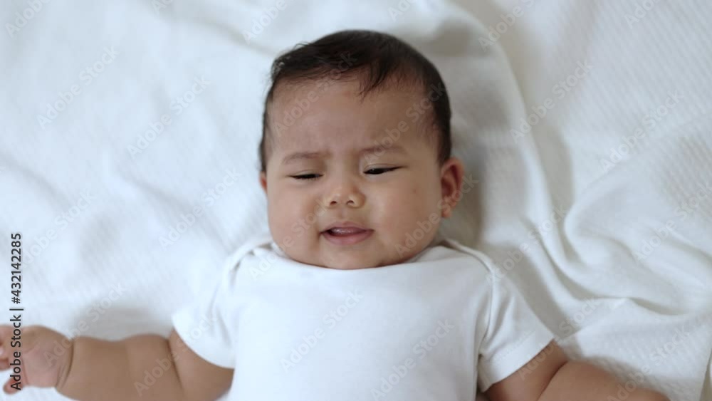 A cute baby in a white dress is crying. Stay with parents in the house A cute baby in a white dress is crying. Stay with parents in the house