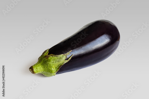 Eggplant with a glossy dark purple surface on a light background