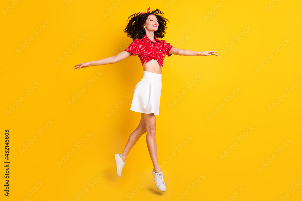 Full length photo of charming lady look go empty space raise hands isolated on yellow color background