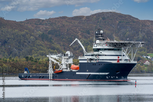 ULSTEINVIK, NORWAY - 2020 MAY 07. Multipurpose Offshore Vessel with big offshore crane inside the Norwegian fjord © Arild