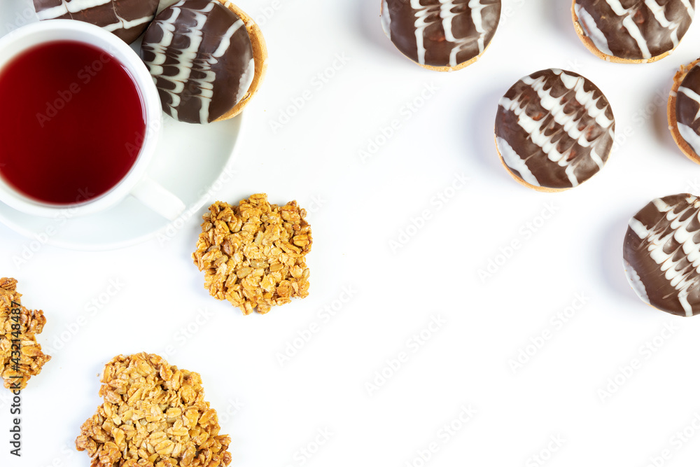Tea in a cup, with oatmeal cookies, chocolate chip cookies, on a white background, isolated, top view Tea in a cup, with oatmeal cookies, chocolate chip cookies, on a white background, isolated, top view