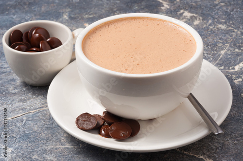 white Cup of hot chocolate with milk on a grey background