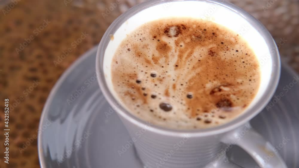 Cappuccino coffee in gray cup and saucer on an old copper table, concept fresh, morning coffee, caffeine addiction, energy boost Cappuccino coffee in gray cup and saucer on an old copper table, concept fresh, morning coffee, caffeine addiction, energy boost