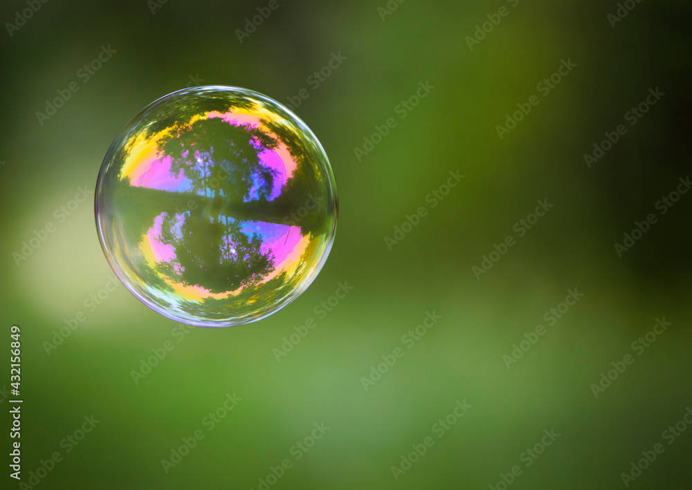 multicolored soap bubble on a green background. Soap bubble. Isolated on green, in spring or summer. reflex, detailed, close-up. multi-colored ball flies. holiday concept, childhood multicolored soap bubble on a green background. Soap bubble. Isolated on green, in spring or summer. reflex, detailed, close-up. multi-colored ball flies. holiday concept, childhood