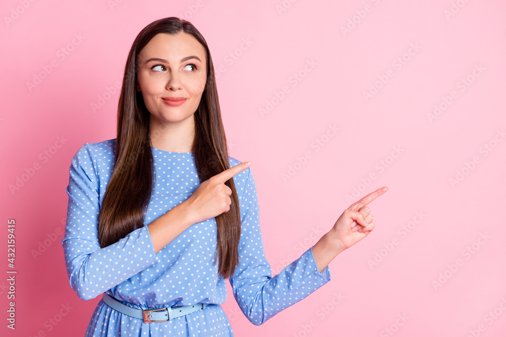 Photo portrait of cute brunette girl showing looking at blank space isolated on pink pastel colorbackground Photo portrait of cute brunette girl showing looking at blank space isolated on pink pastel colorbackground